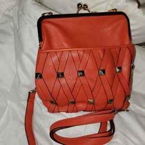 Orange, leather handbag, snap closure